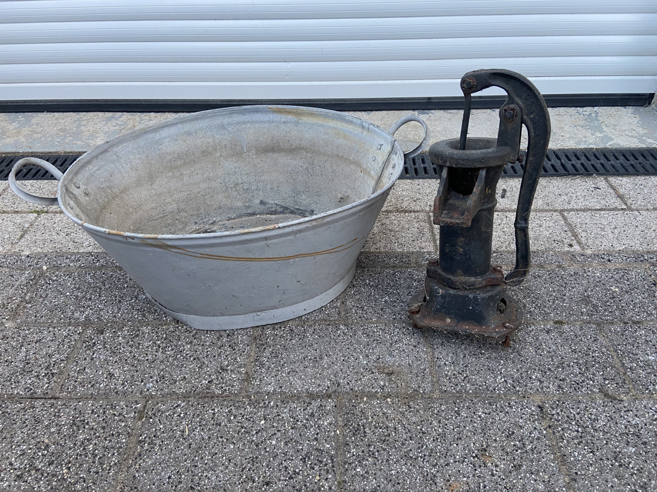 Metal pump and galvanised garden planter