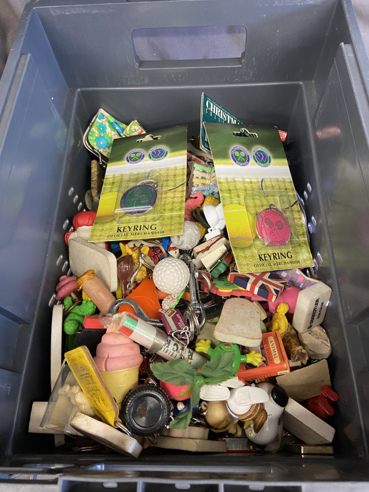 Box full of key rings and collectable rubbers