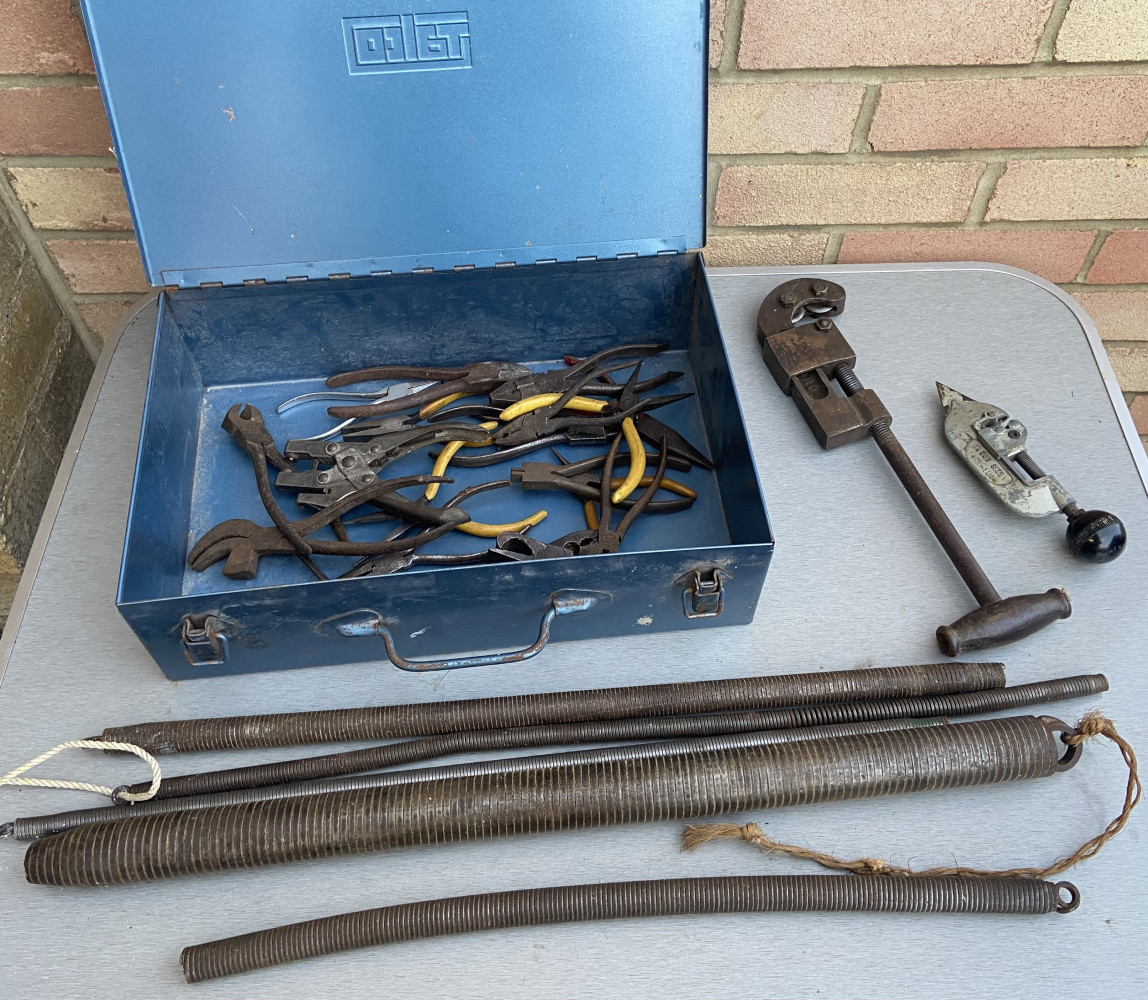 Metal box full of pliers and cutters, 2 pipe cutters and pipe bender springs