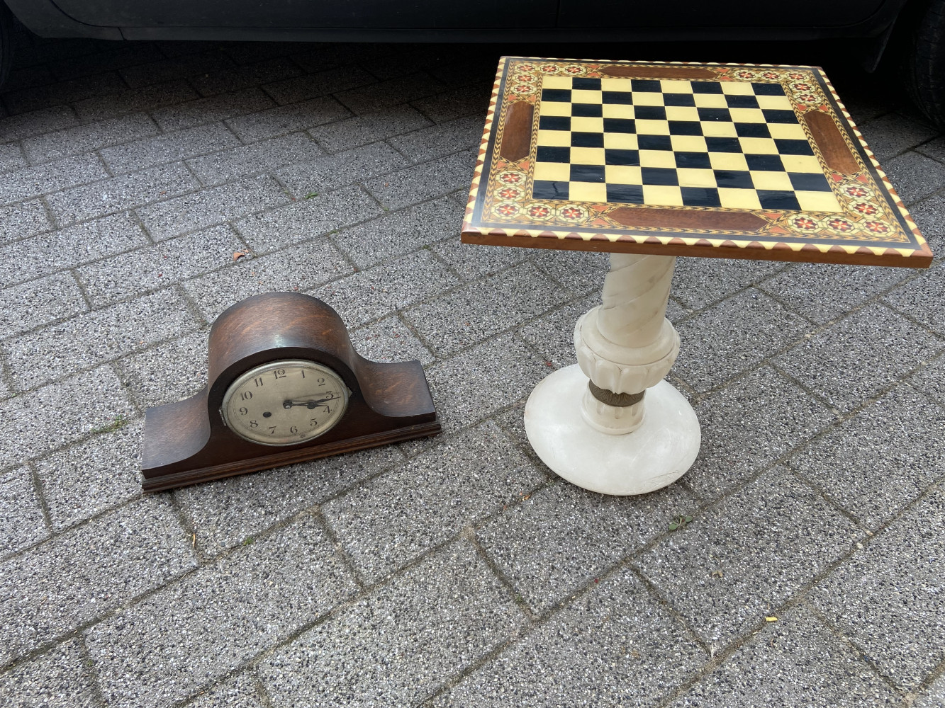 Antique clock and inlaid chess table on heavy stone base