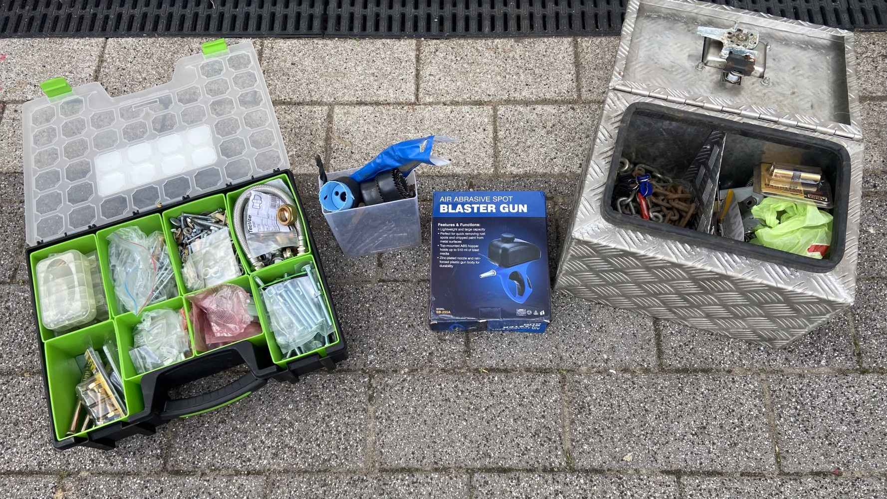 Large drill bits, organiser box full up incl plumbing items, safe box with lock full of chains and locks and a blaster tool