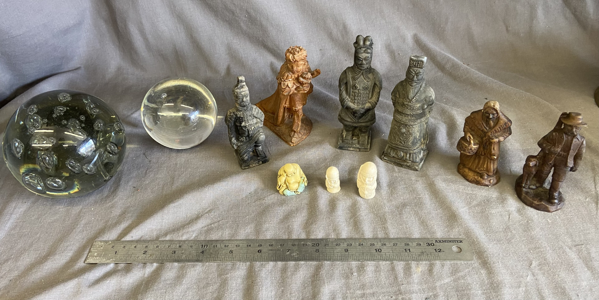 2 glass paperweights and a selection of figures