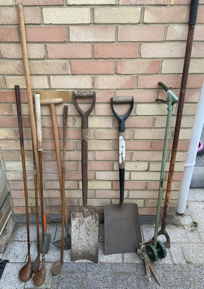 Selection of garden tools and vintage golf clubs