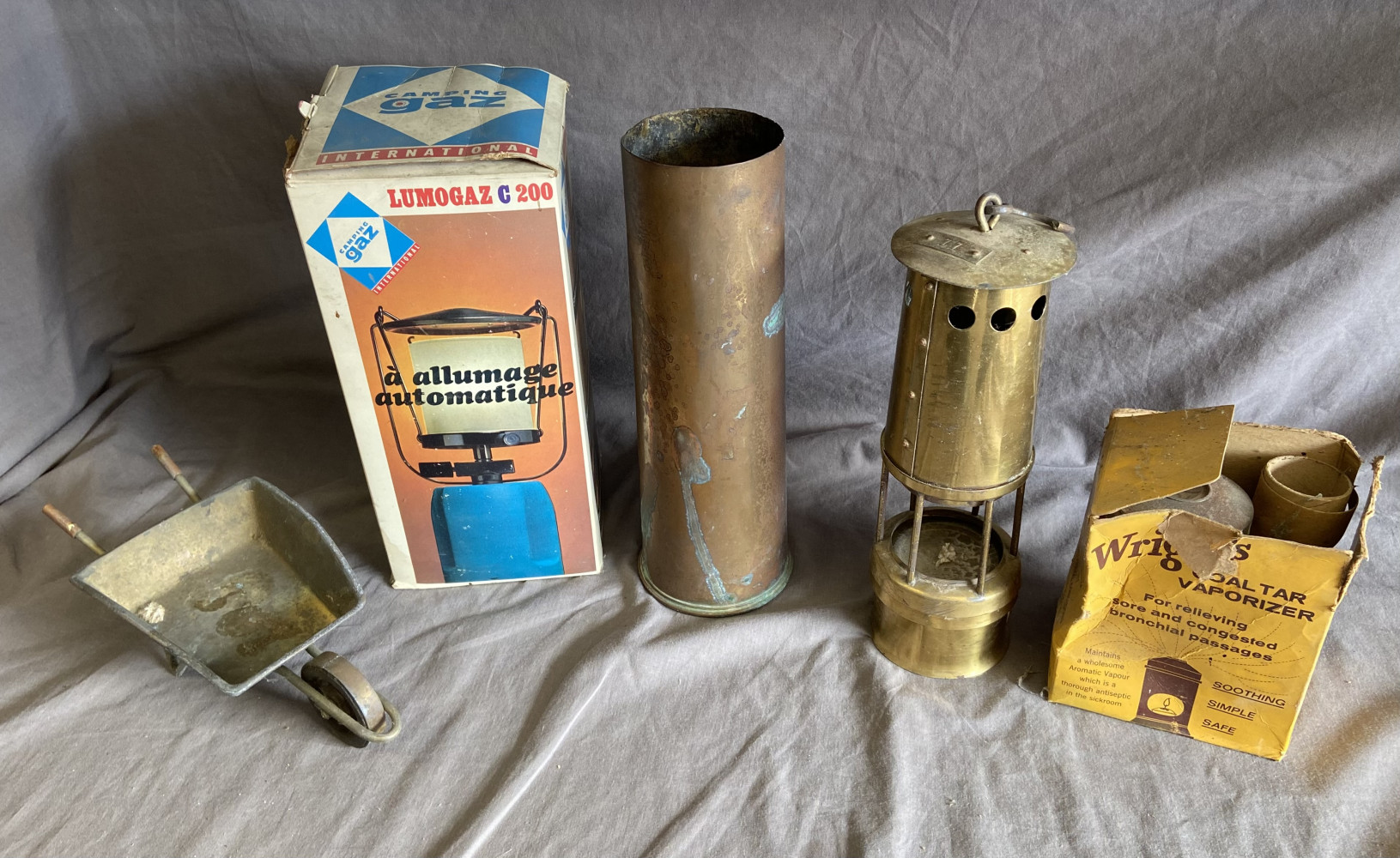 Shell casing, miners lamp, gaz lamp, brass wheelbarrow and vintage vaporiser