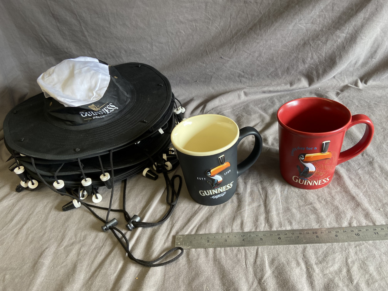 7 Guinness hats and 2 large Guinness mugs