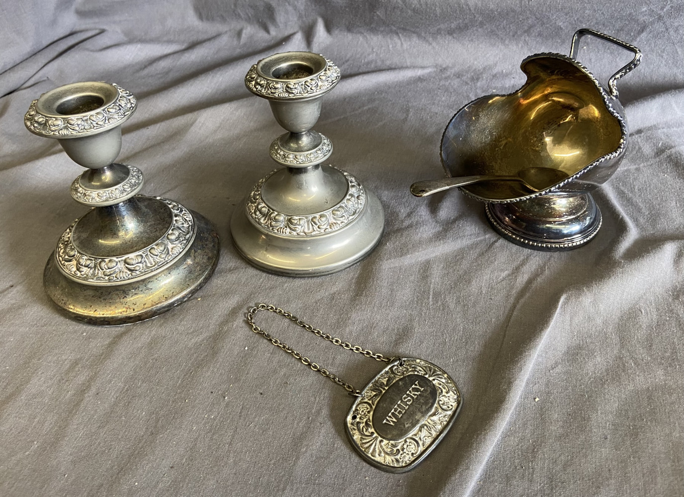 Silver plated drinks label, pair of candle sticks and sugar bowl designed in the shape of a coal scuttle