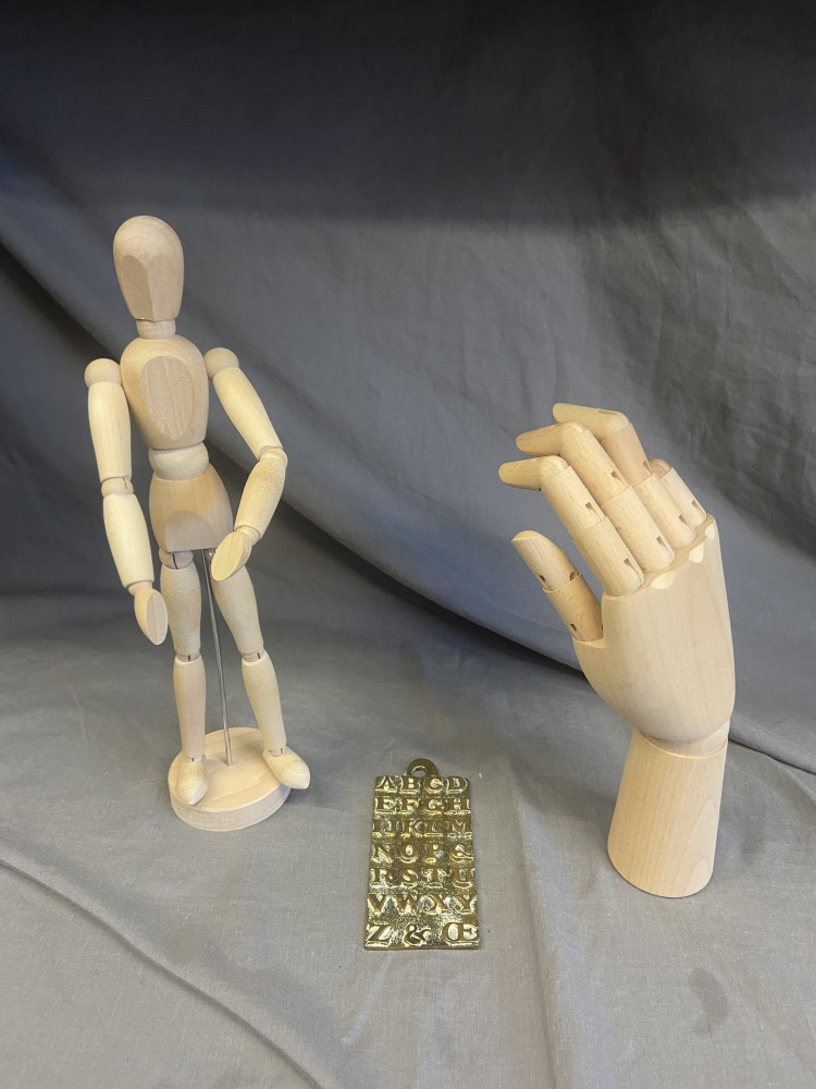 Wooden hand and mannequin and brass alphabet plaque