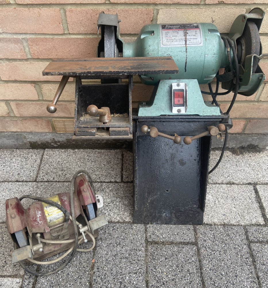 2 grinders one on metal wall stand