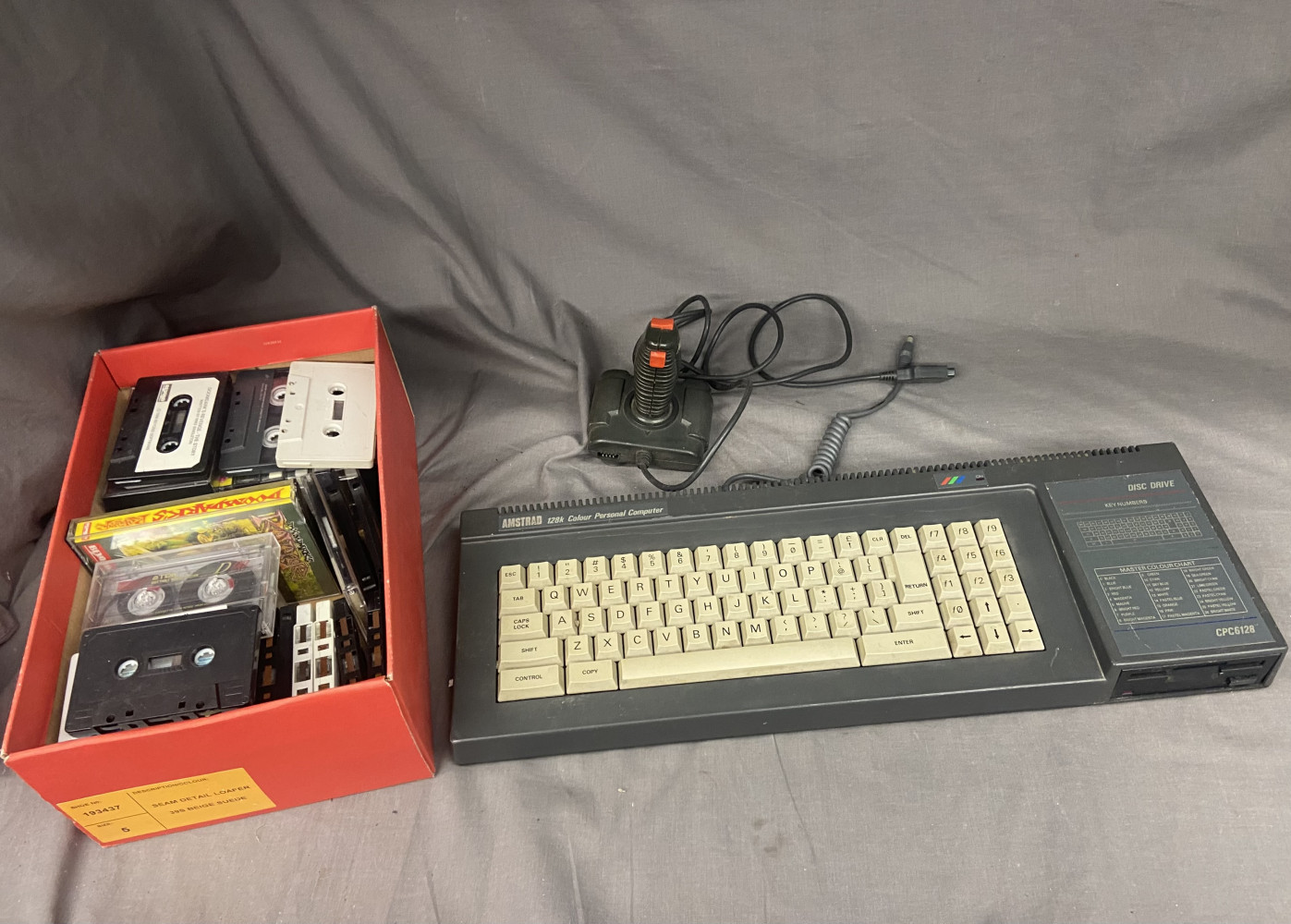 Amstrad computer, controller and box of tapes