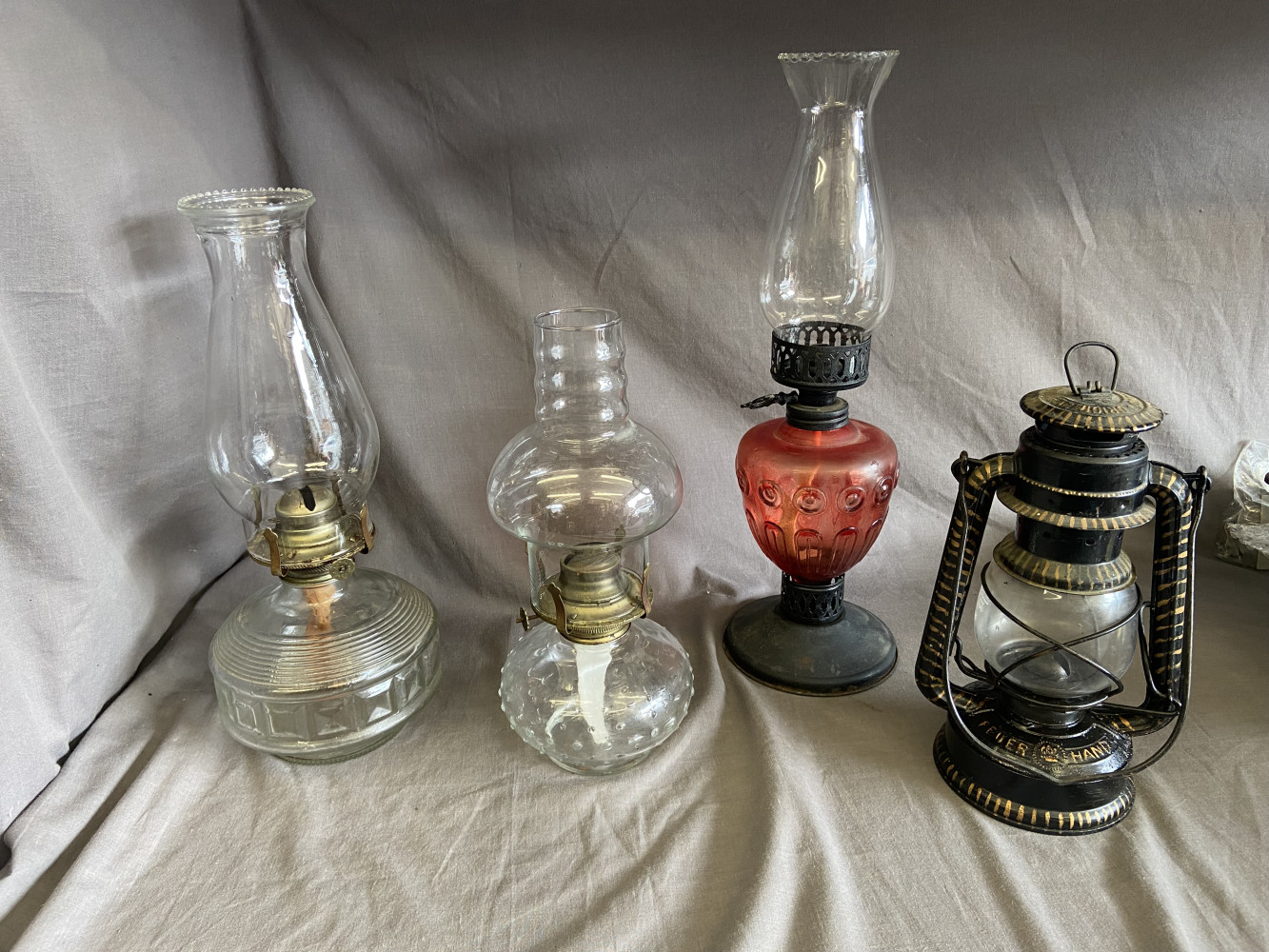 3 oil lamps and hurricane lamp