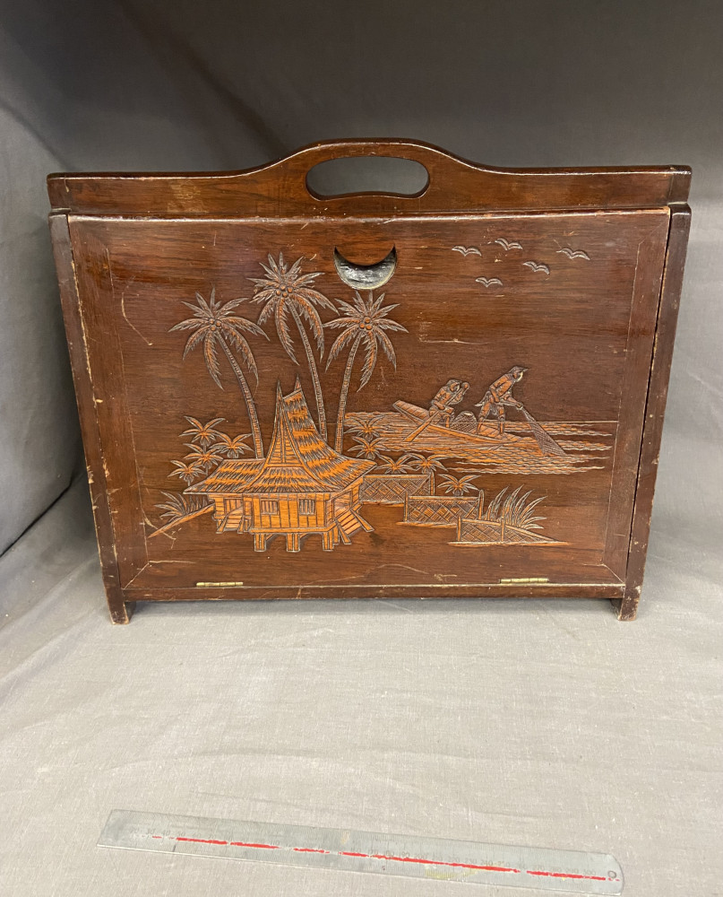 Vintage magazine or letter rack, made from camphor wood, featuring an Oriental-inspired carved scene.