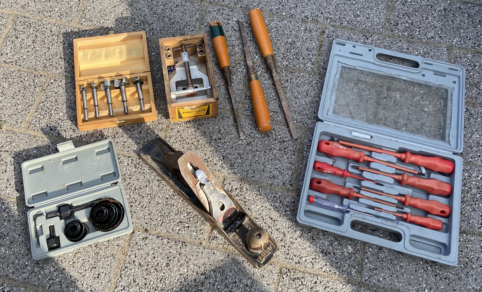 Cutters in wooden box, screw drive set, very large metal plane, chisels and other tools