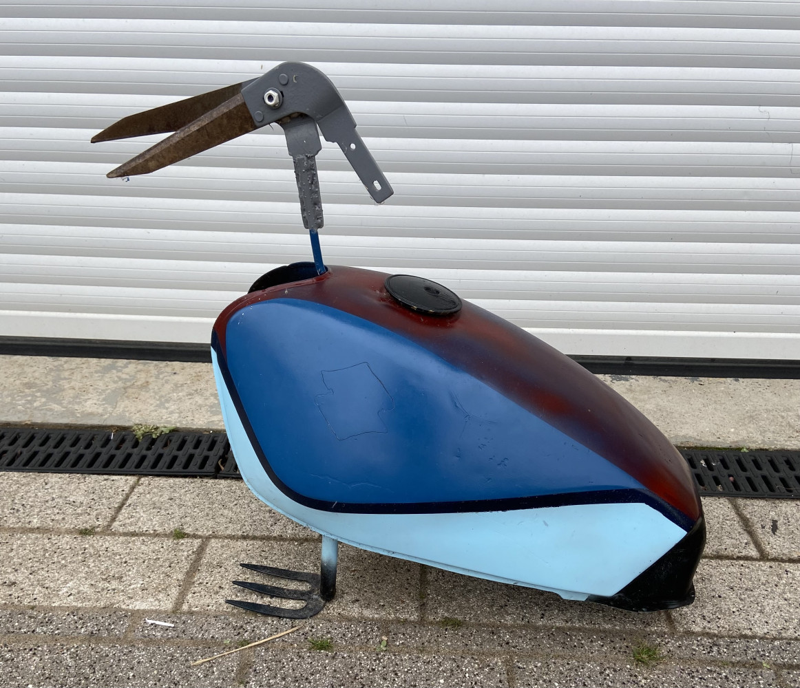 Fantastic garden sculpture of a bird made from and old fuel tank