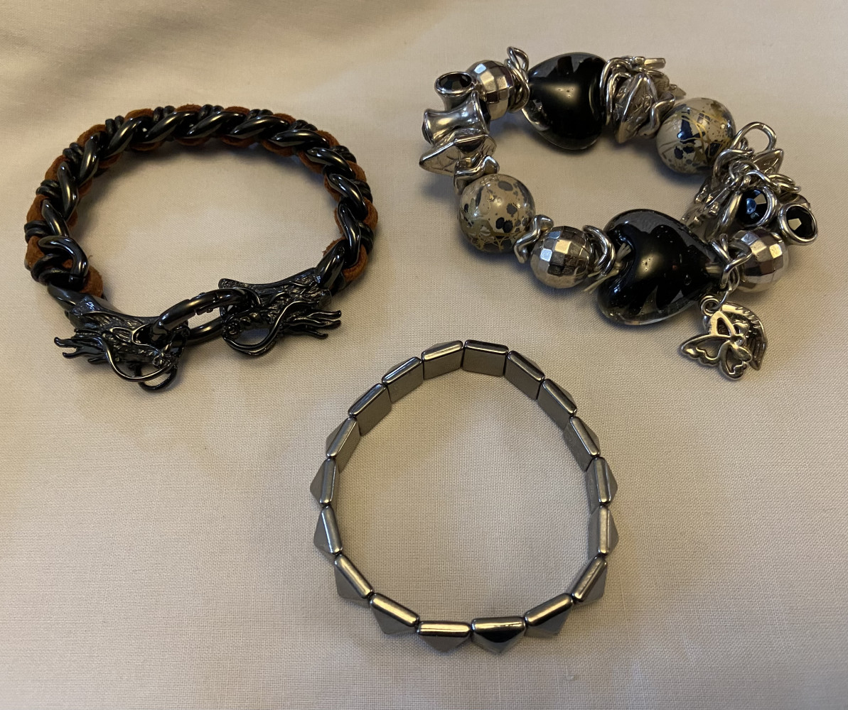 3 bracelets, one with dragon heads on it