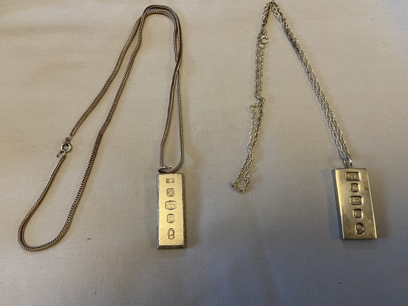Two silver ingots with chains, 76.4 grams or 2.69 ounces, hallmarked in 1977 to commemorate the Queen's Silver Jubilee,