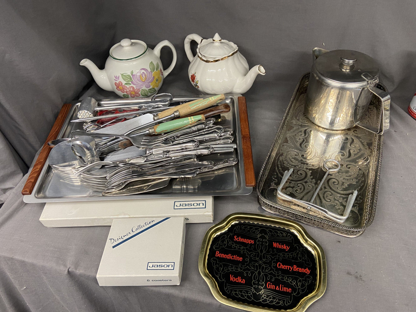 Teapots, cutlery items, table mats and metal trays