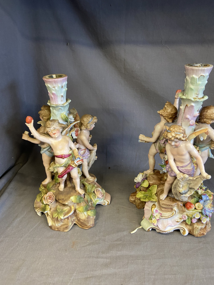 2 stizendorf victorian candle holders with a trio of figures around the base of each