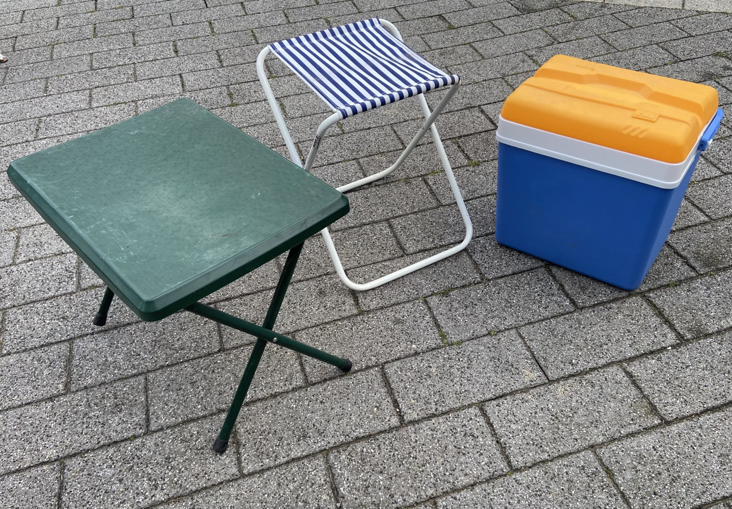 Outdoor picnic items, folding chair, table and cool box