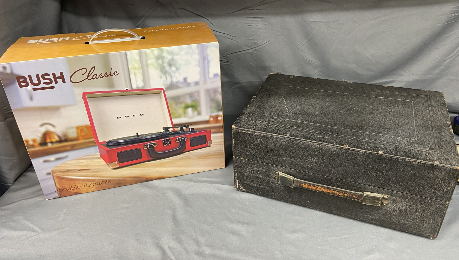 2 portable Record players, one A vintage Colombia, No.201, portable gramophone, in a black fabric covered case and new bush player in box