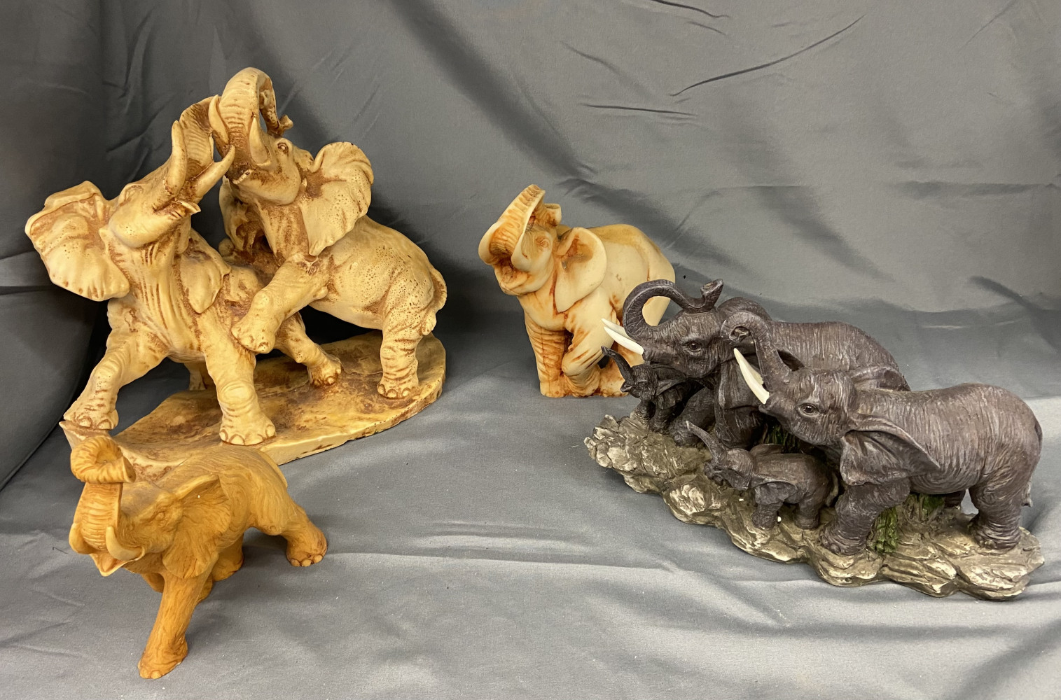Four elephant figures largest one 28cms across