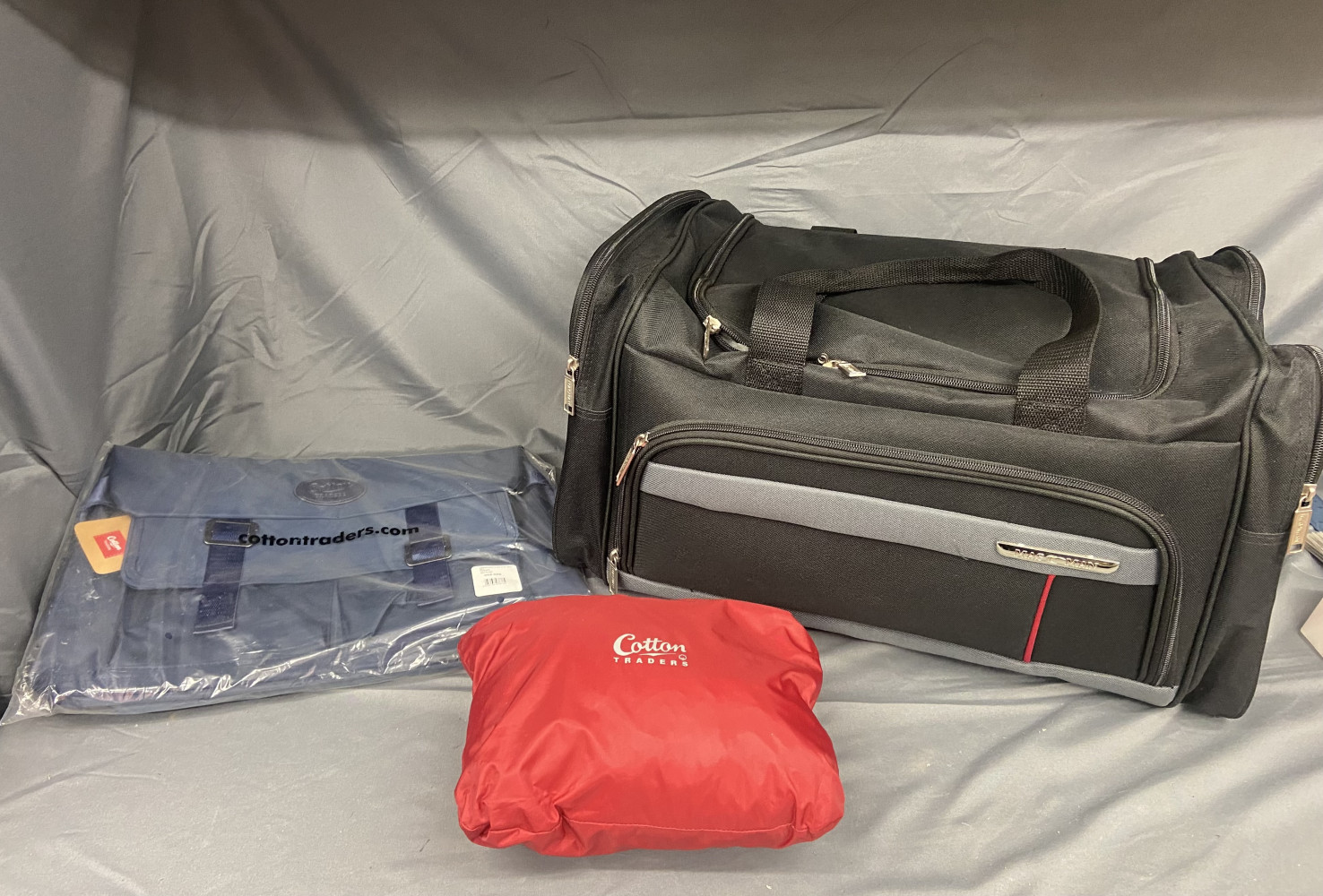 Cotton Traders poncho, smart black carry bag and Cotton Traders Navy Satchel