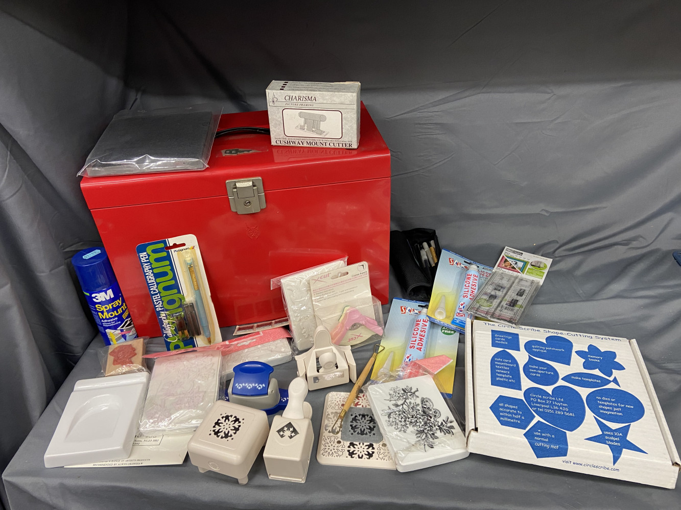 Metal box full up with craft cutters and other craft items