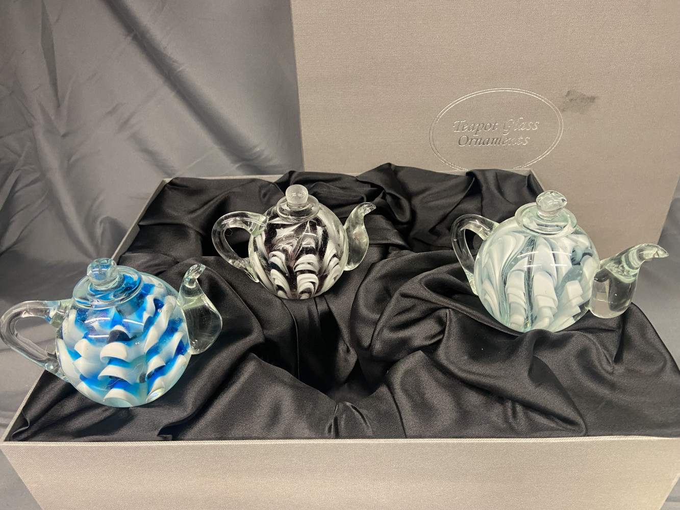 Set of three glass teapot paperweights in box