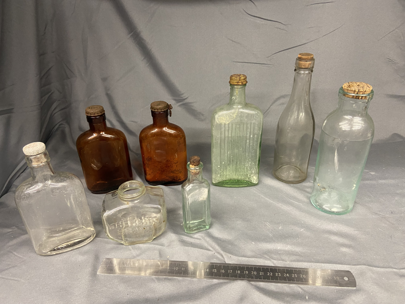 Old bottles including poisonous one and a thermos one