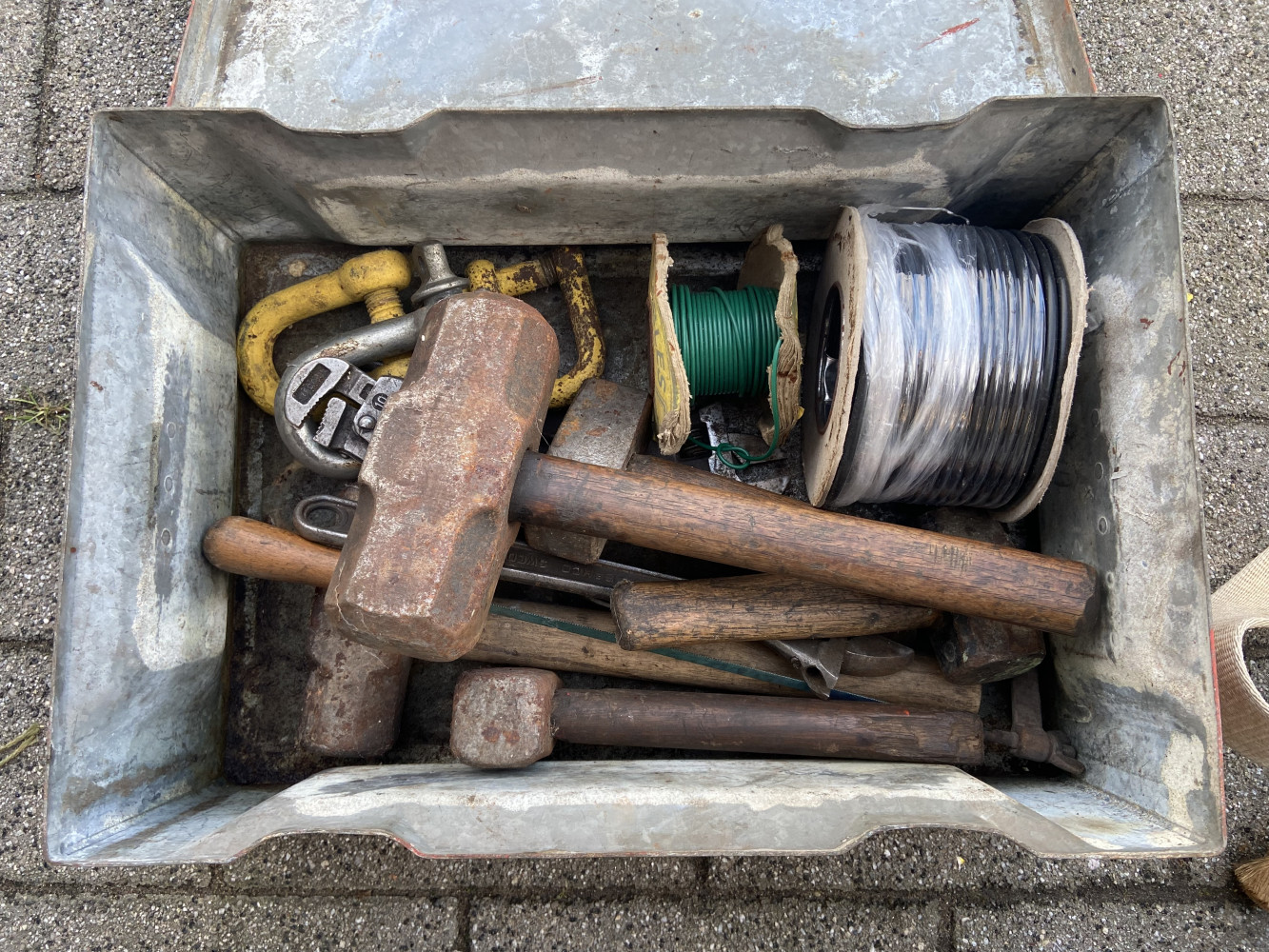 Heavy metal tool box full of tools including very large hammer called Dave