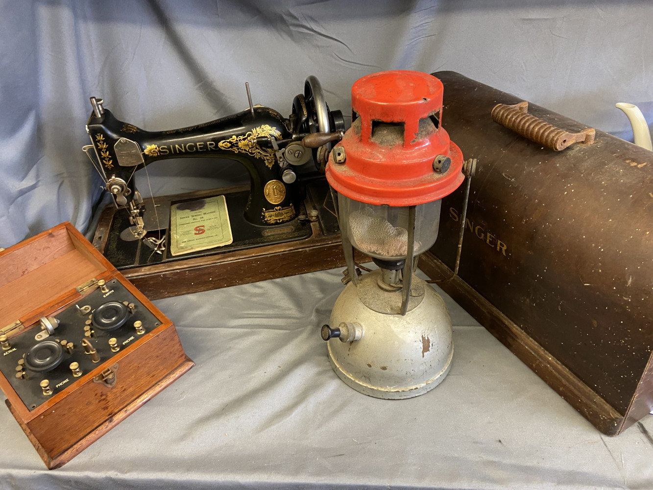 Hurricane lamp, singer sewing machine with no key and a Revophone crystal radio set with broken crystal