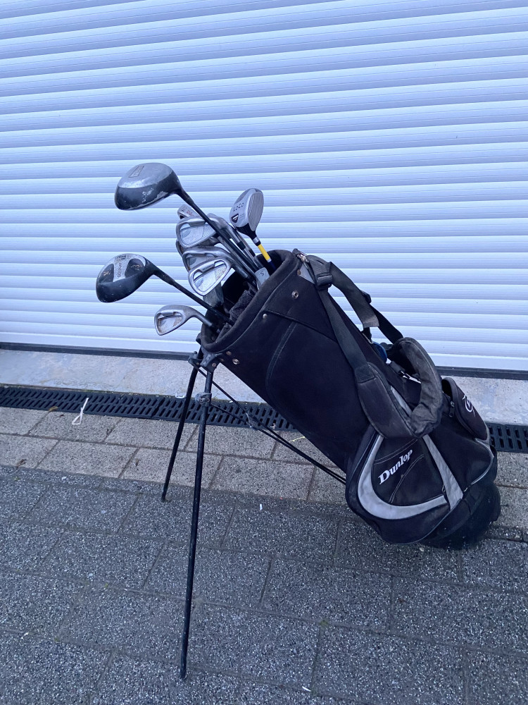 Set of clubs with bag on stand
