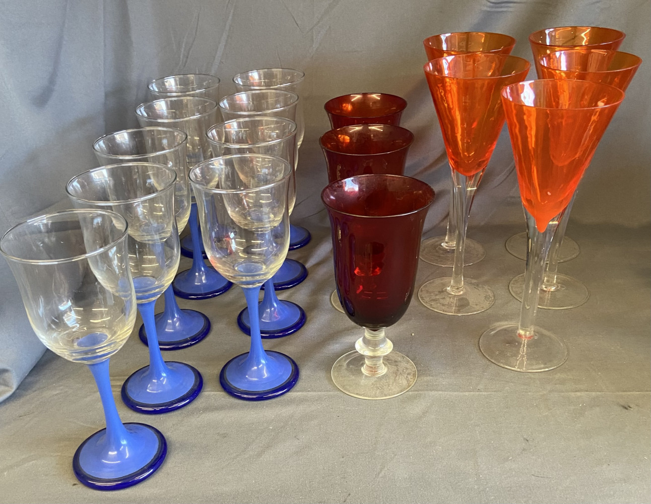 Beautiful Retro Glasses, 9 blue stem glasses, 5 large orange 23cms tall and 3 smaller cranberry topped glasses