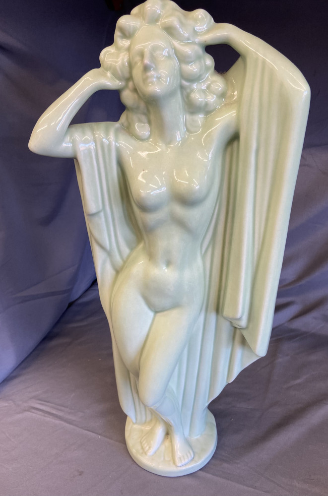 An Art Deco style porcelain figure, of a scantily clad maiden, green celadon glaze, 49cm high