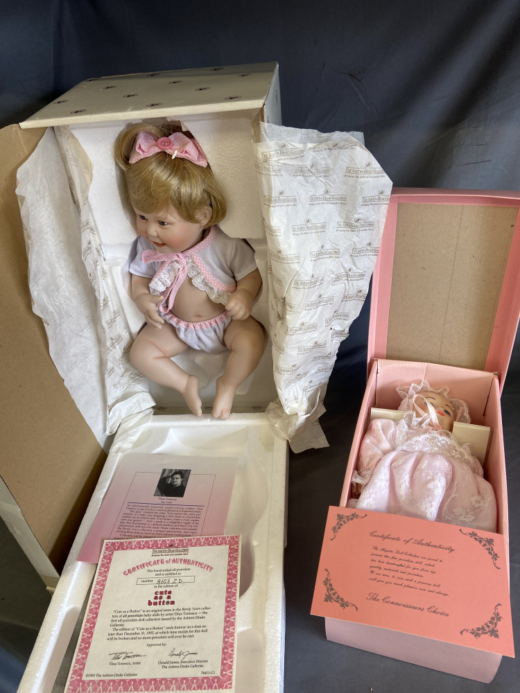Two Boxes Collectable dolls, Cute as a Button" porcelain baby doll from The Ashton-Drake Galleries and porcelain baby doll from The Majestic Doll Collection