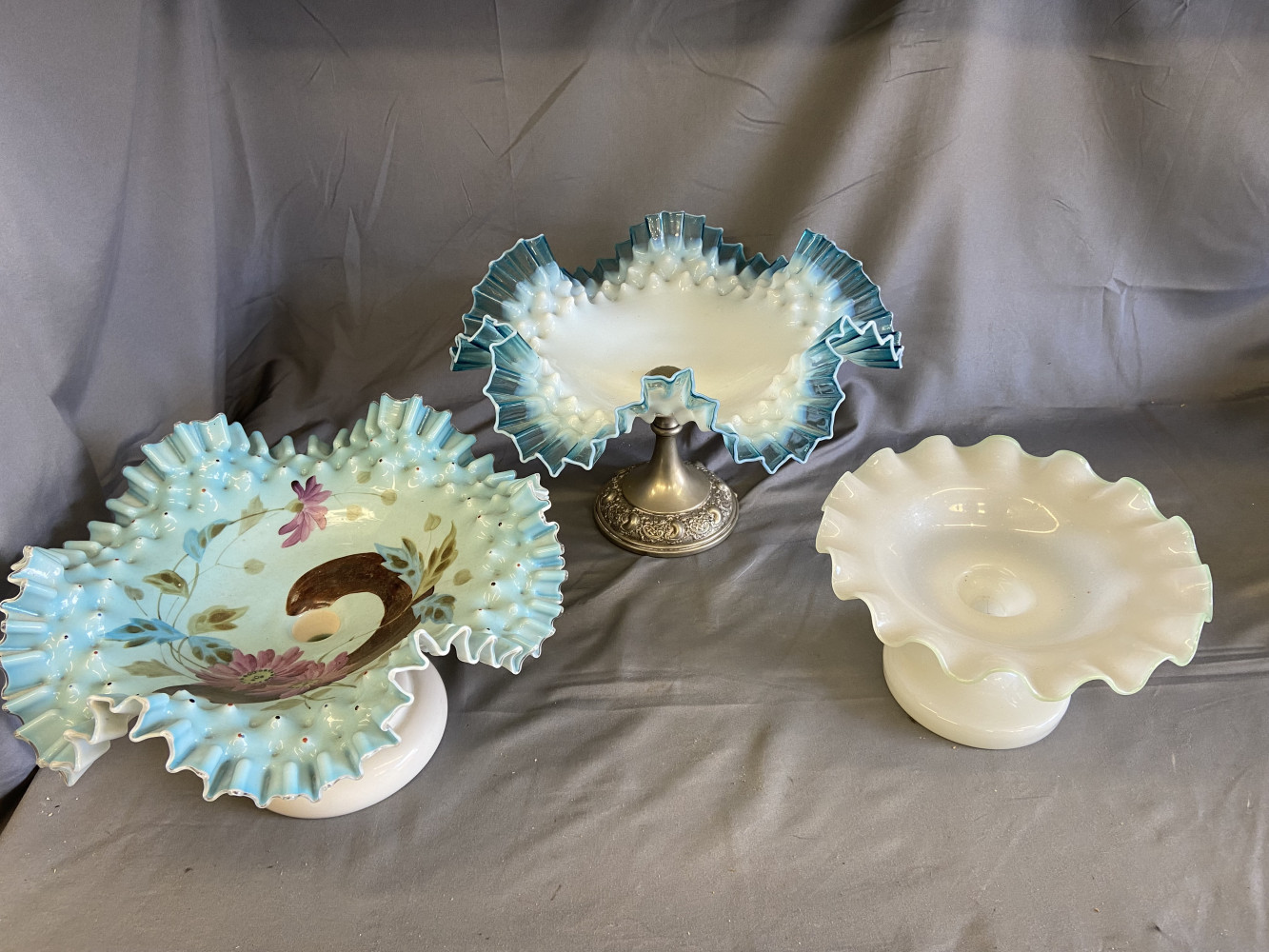 Blue glass ruffled edge bowl on stand, milk glass and painted glass bowls on stands