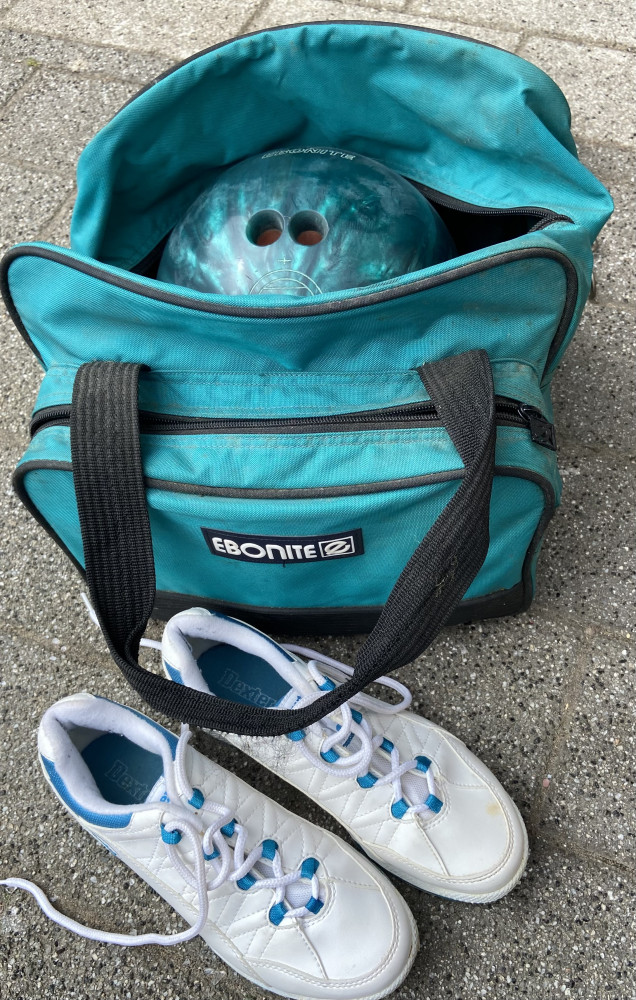 Ebonite bowling ball in bag with shoes