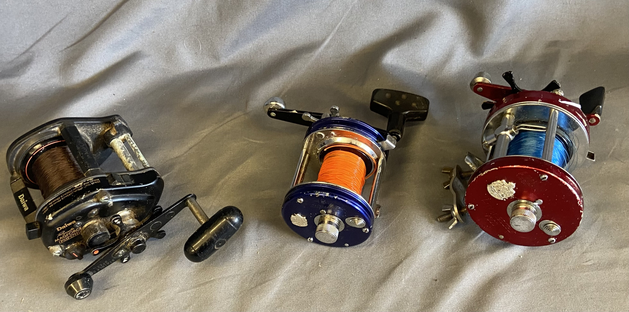 3 sea fishing reels, Abu Garcia Ambassadeur 5000, another Abu Garcia Ambassadeur and a Daiwa Procaster Magforce PMF57H baitcasting fishing reel