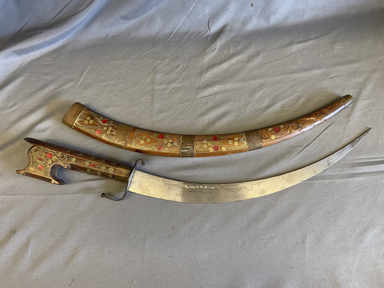 PERSIAN DAGGER WITH SCABBARD Late 19th Century Both scabbard and handle with silvered wire inlay, brass mounts and red painted highlights