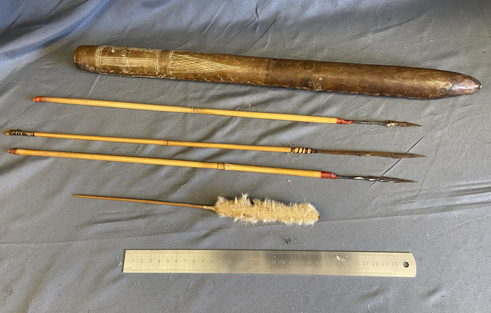 Set of traditional or ethnographic darts or arrows In hide holder