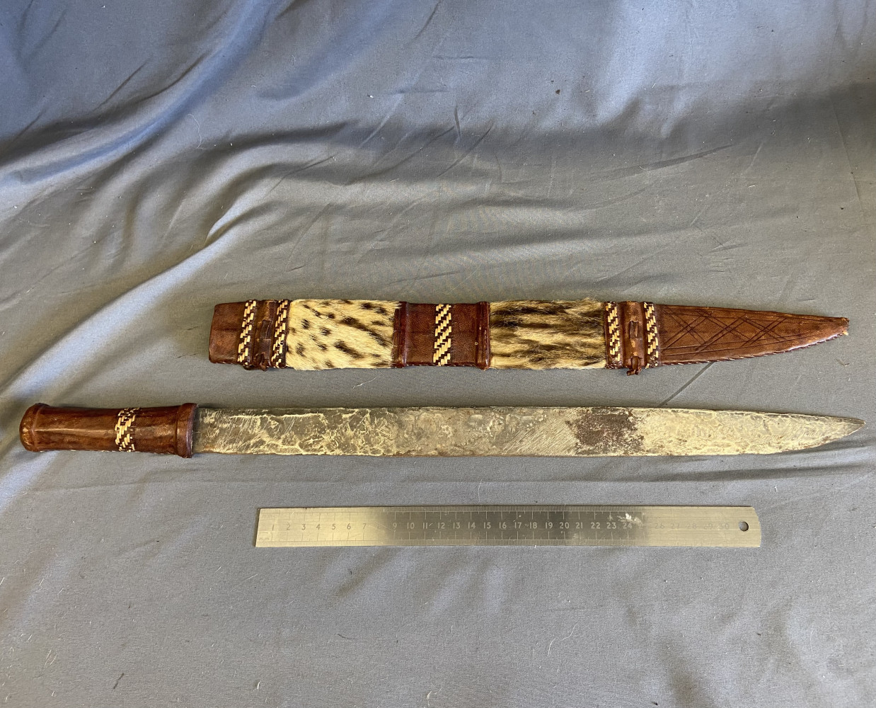 A Leather Handled Machete with Animal Skin Scabbard, Possibly African Tribal