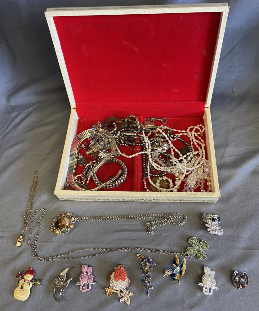Jewellery box full of broaches, necklaces and other jewellery items