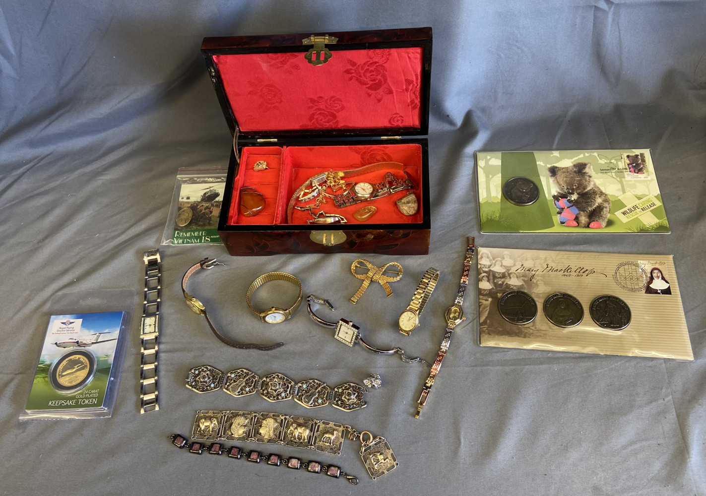 Jewellery box full of watches, bracelets, coins and other jewellery items