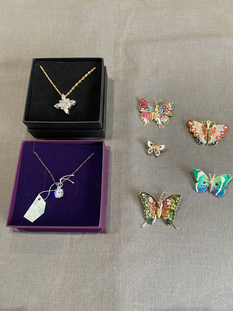 5 butterfly broaches and two sparkly necklaces