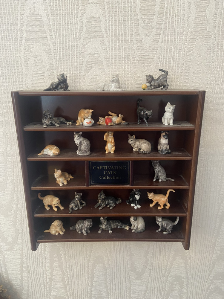 Vintage Danbury Mint Captivating Cats collection on small wall unit