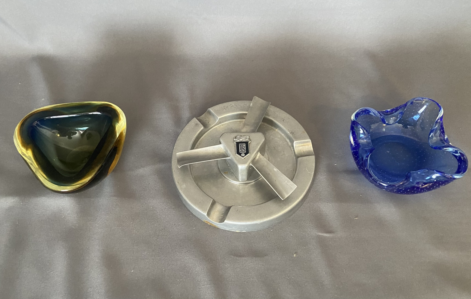 3 ash trays including vintage Rolls-Royce themed metal hubcap designed as three-blade spinner