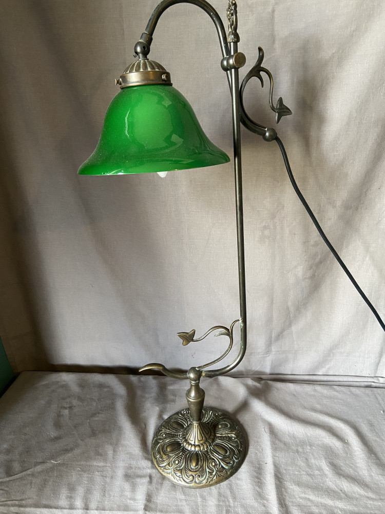 Vintage style brass table lamp featuring an adjustable swan neck and a green glass shade, chip on shade