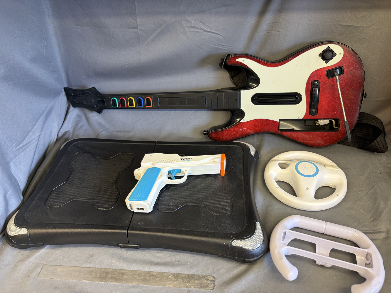 Nintendo WII guitar, steering wheels, gun and board