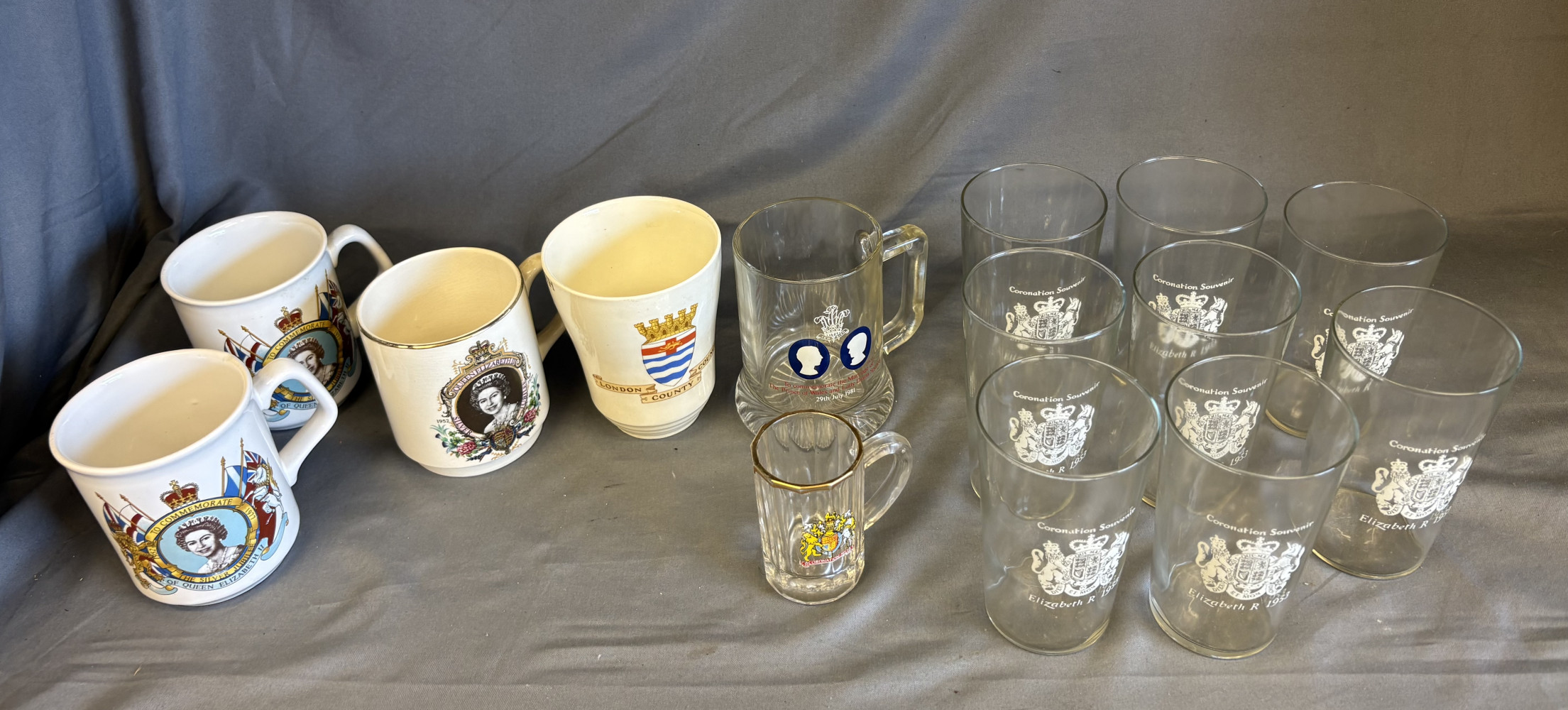 Collection of royal memorabilia including mugs and glasses