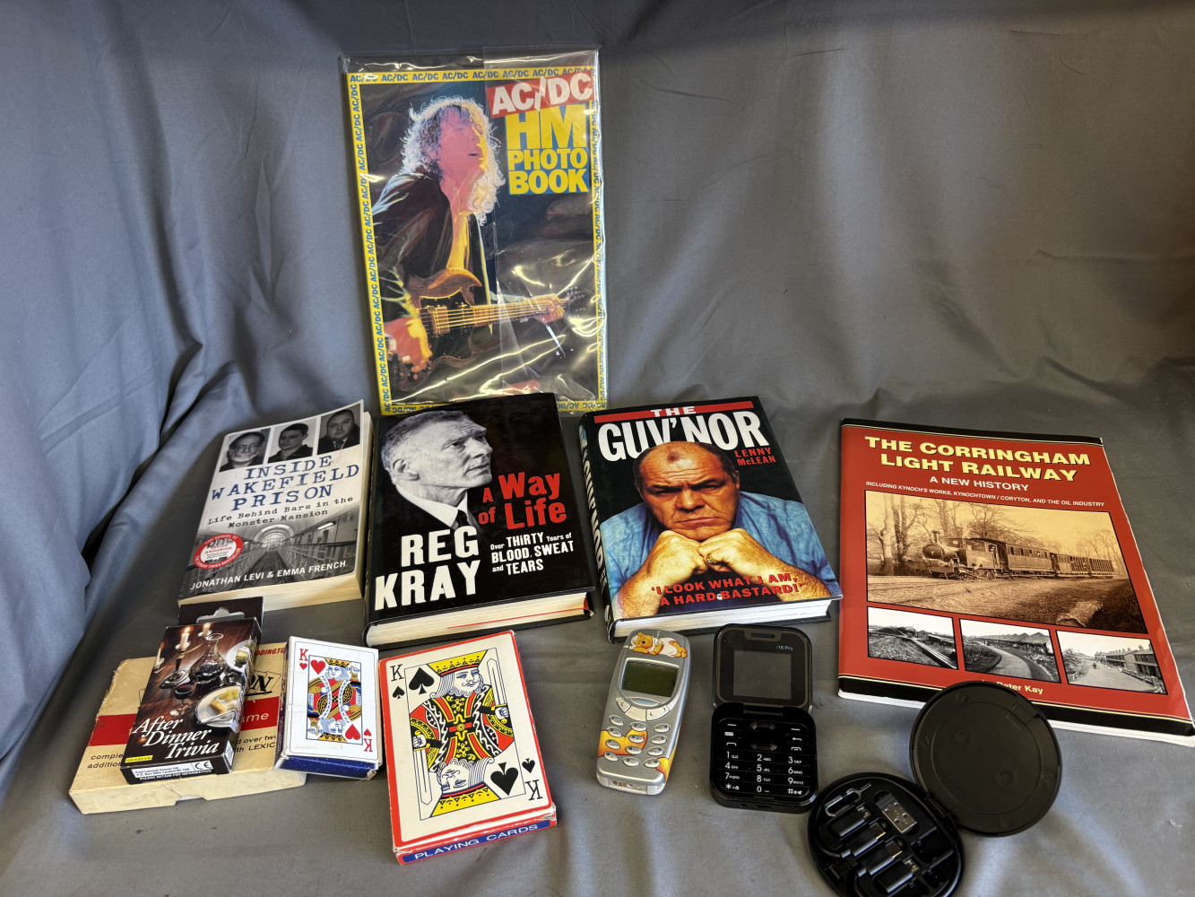 Nokia and i16 Pro mini flip phones, pocket dictionary, cards, local history book and other books