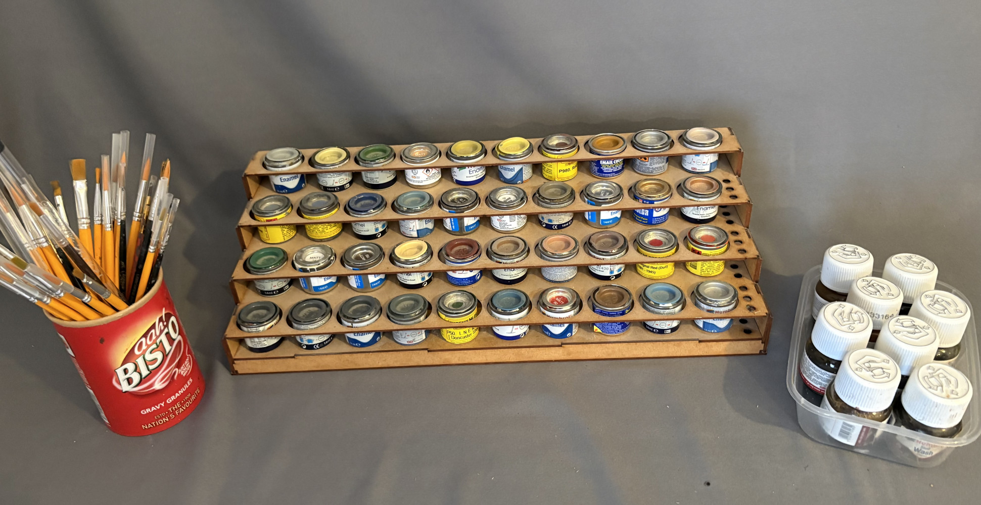 Model painting equipment loads of brushes and paints